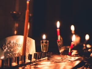A table topped with candles and a cake covered in frosting